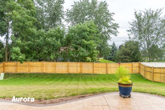 615 Camellia Ave, Aurora, IL 60505 - fenced backyard with a patio area