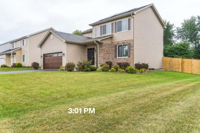 615 Camellia Ave, Aurora, IL 60505 - traditional home featuring a garage and asphalt driveway