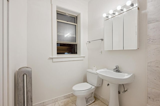 5452 S Cornell Ave Unit 1E, Chicago, IL 60615 - half bathroom with toilet, baseboards, and tile patterned flooring
