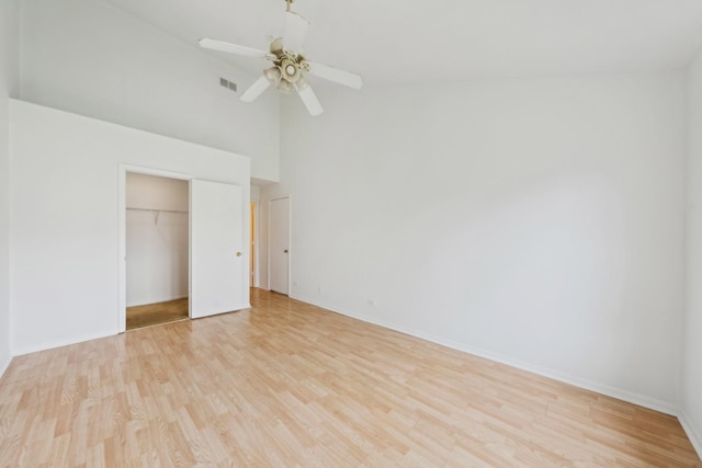 611 Kingsbridge Dr, Carol Stream, IL 60188 - unfurnished bedroom with light wood-style floors, high vaulted ceiling, baseboards, a closet, and a ceiling fan