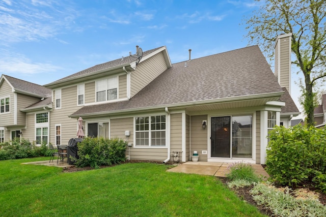 611 Kingsbridge Dr, Carol Stream, IL 60188 - rear view of house featuring a patio, a shingled roof, a lawn, and a chimney