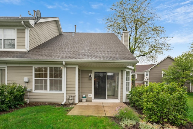 611 Kingsbridge Dr, Carol Stream, IL 60188 - back of property featuring roof with shingles, a patio area, a yard, and a chimney