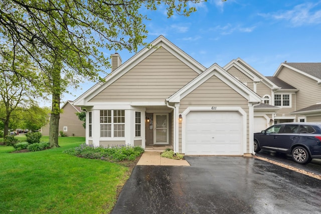 611 Kingsbridge Dr, Carol Stream, IL 60188 - view of front of property with asphalt driveway, a front lawn, a garage, and a chimney