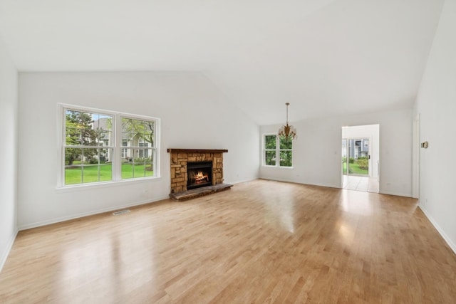 611 Kingsbridge Dr, Carol Stream, IL 60188 - unfurnished living room with light wood-type flooring, vaulted ceiling, a fireplace, and baseboards