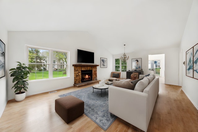 611 Kingsbridge Dr, Carol Stream, IL 60188 - living area with light wood finished floors, vaulted ceiling, healthy amount of natural light, and a stone fireplace