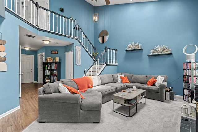 870 N Auburn Woods Dr, Palatine, IL 60067 - living area featuring baseboards, stairs, a ceiling fan, a high ceiling, and wood finished floors