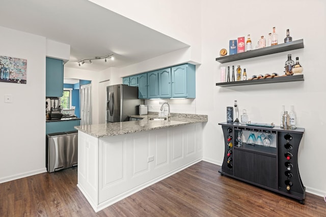 870 N Auburn Woods Dr, Palatine, IL 60067 - kitchen with stainless steel fridge, blue cabinets, dark wood-style floors, a sink, and a peninsula