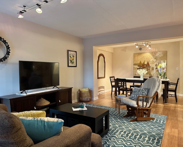 828 Graceland Ave Unit 404, Des Plaines, IL 60016 - living area featuring track lighting, baseboards, and wood finished floors