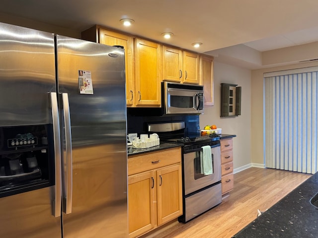 828 Graceland Ave Unit 404, Des Plaines, IL 60016 - kitchen with stainless steel appliances, light wood-style flooring, baseboards, and dark stone counters