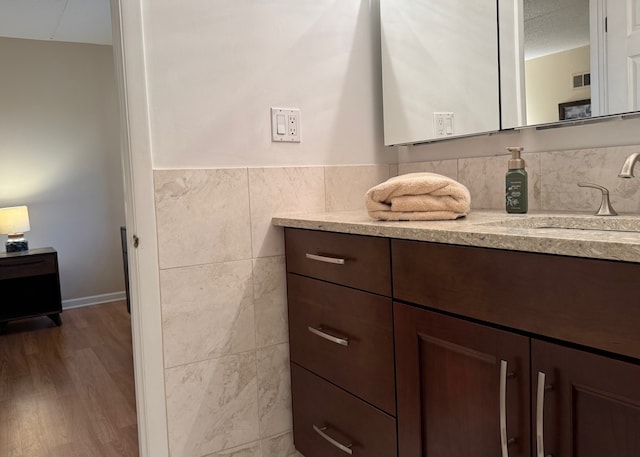 828 Graceland Ave Unit 404, Des Plaines, IL 60016 - bathroom featuring vanity, wood finished floors, and tile walls