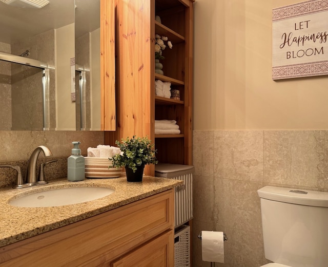 828 Graceland Ave Unit 404, Des Plaines, IL 60016 - bathroom with tile walls, vanity, a stall shower, toilet, and wainscoting