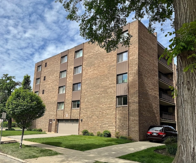 828 Graceland Ave Unit 404, Des Plaines, IL 60016 - view of apartment building / complex with a garage and concrete driveway