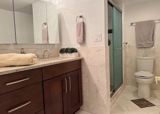 828 Graceland Ave Unit 404, Des Plaines, IL 60016 - bathroom with tile walls, vanity, a stall shower, toilet, and a wainscoted wall