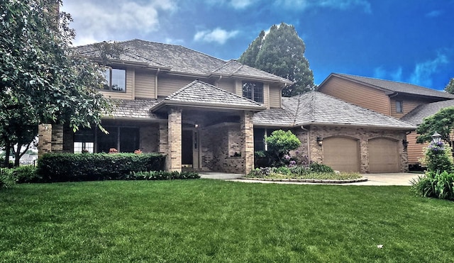 2903 Prairie Meadow Dr, Champaign, IL 61822 - traditional-style house with a garage, brick siding, a front yard, and driveway