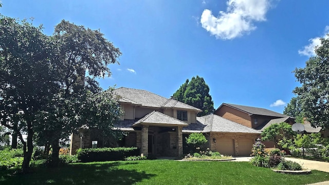 2903 Prairie Meadow Dr, Champaign, IL 61822 - view of front of house featuring a front lawn, an attached garage, concrete driveway, and brick siding