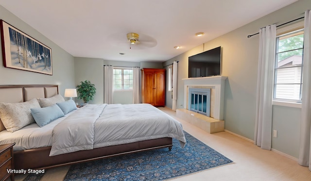 2903 Prairie Meadow Dr, Champaign, IL 61822 - carpeted bedroom with a fireplace and ceiling fan