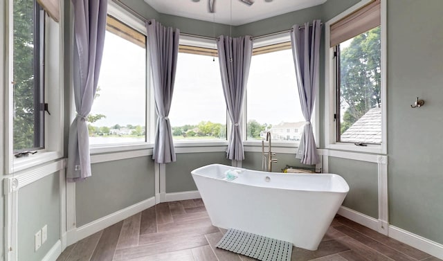 2903 Prairie Meadow Dr, Champaign, IL 61822 - bathroom with baseboards, a soaking tub, and healthy amount of natural light