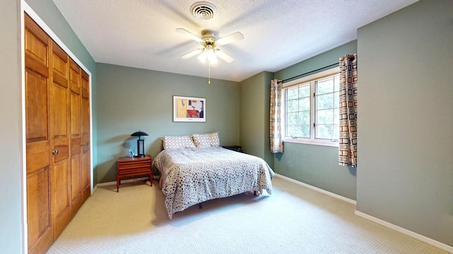 2903 Prairie Meadow Dr, Champaign, IL 61822 - bedroom with a closet, light colored carpet, baseboards, a ceiling fan, and a textured ceiling