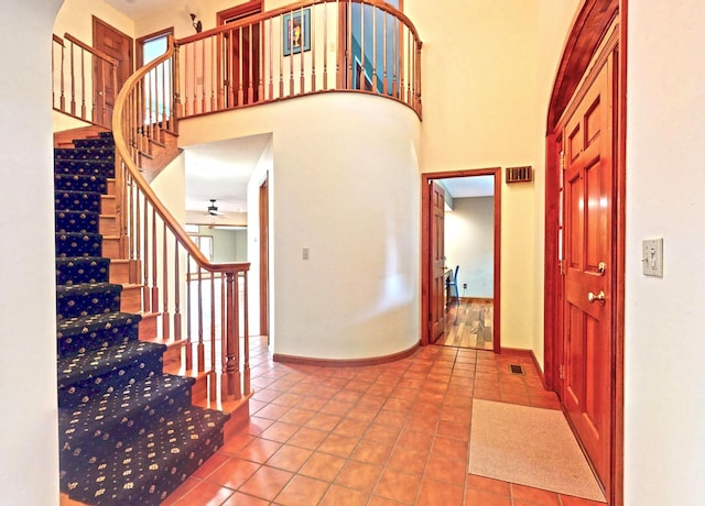2903 Prairie Meadow Dr, Champaign, IL 61822 - foyer featuring tile patterned flooring, stairs, baseboards, and a high ceiling