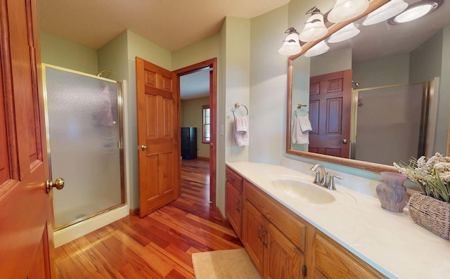 2903 Prairie Meadow Dr, Champaign, IL 61822 - full bathroom featuring wood finished floors, a shower stall, and vanity