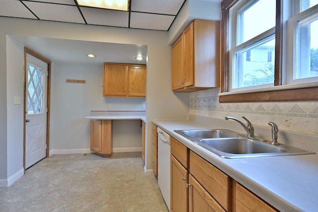 1021 Vine St, Joliet, IL 60435 - kitchen featuring a sink, baseboards, white dishwasher, and light countertops