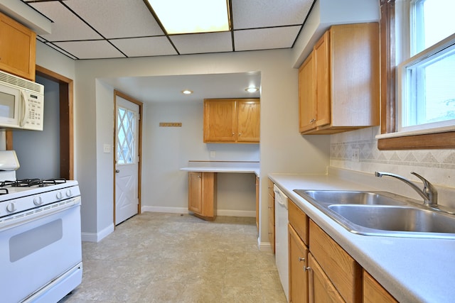1021 Vine St, Joliet, IL 60435 - kitchen with white appliances, a sink, light countertops, baseboards, and a paneled ceiling