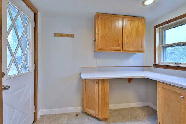 1021 Vine St, Joliet, IL 60435 - kitchen featuring light countertops, baseboards, and brown cabinets