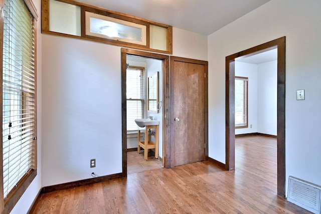 1021 Vine St, Joliet, IL 60435 - bedroom with multiple windows, wood finished floors, and baseboards
