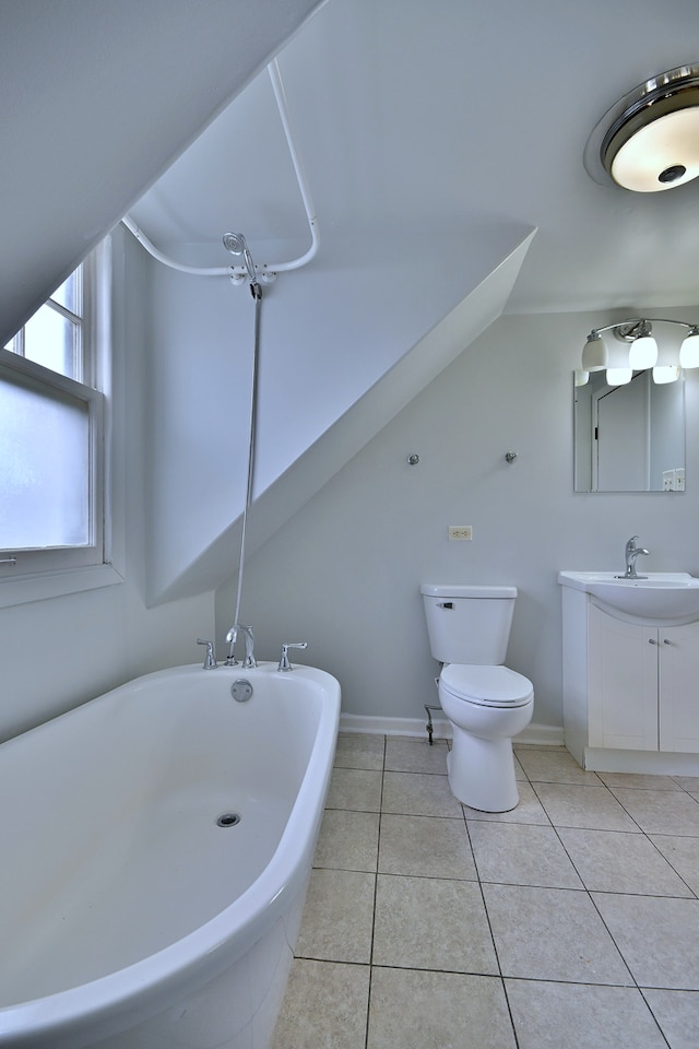 1021 Vine St, Joliet, IL 60435 - full bathroom featuring a soaking tub, vanity, tile patterned flooring, toilet, and baseboards