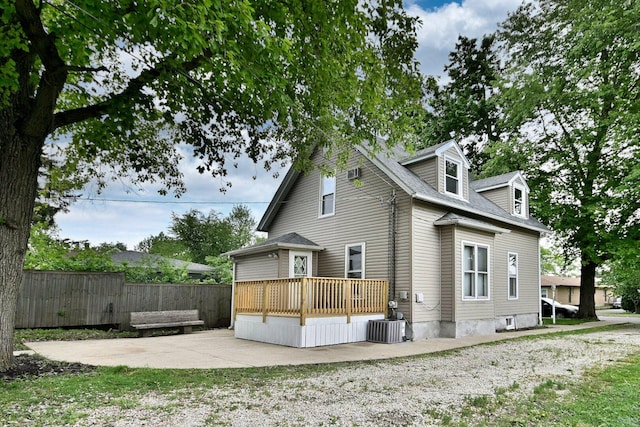 1021 Vine St, Joliet, IL 60435 - rear view of property featuring a wooden deck, a patio area, and central AC unit