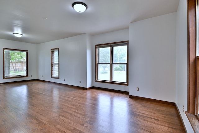 1021 Vine St, Joliet, IL 60435 - empty room featuring plenty of natural light, dark wood-type flooring, and baseboards