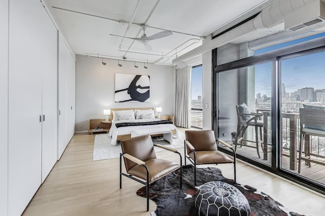 1530 S State St Unit 17B, Chicago, IL 60605 - bedroom featuring access to exterior, light wood-type flooring, track lighting, and a skyline view