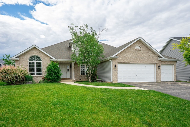 1924 Prestwold Pl, Machesney Park, IL 61115 - view of front of property featuring brick siding, driveway, an attached garage, roof with shingles, and a front yard