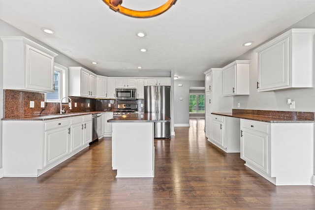 1924 Prestwold Pl, Machesney Park, IL 61115 - kitchen featuring appliances with stainless steel finishes, dark countertops, dark wood-style flooring, tasteful backsplash, and recessed lighting