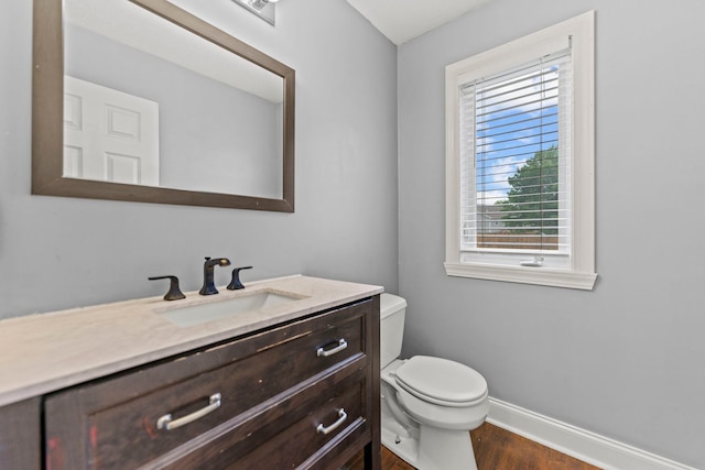 1924 Prestwold Pl, Machesney Park, IL 61115 - bathroom featuring baseboards, vanity, toilet, and wood finished floors