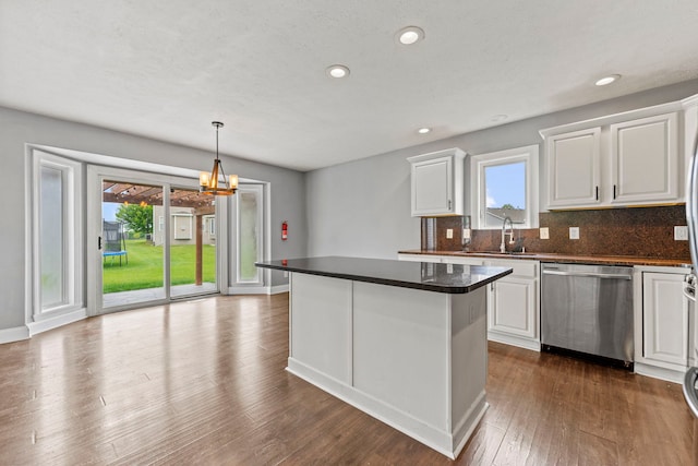 1924 Prestwold Pl, Machesney Park, IL 61115 - kitchen with stainless steel dishwasher, a sink, dark countertops, white cabinets, and recessed lighting