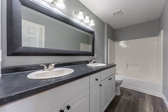 1924 Prestwold Pl, Machesney Park, IL 61115 - full bathroom with toilet, double vanity, wood finished floors, and shower / tub combination
