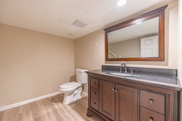 1924 Prestwold Pl, Machesney Park, IL 61115 - half bathroom featuring baseboards, wood finished floors, vanity, and toilet