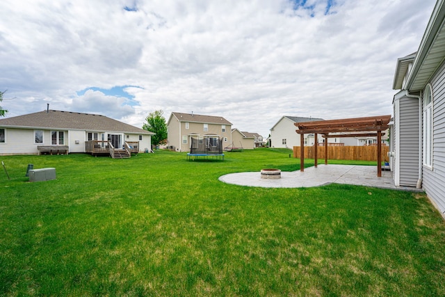 1924 Prestwold Pl, Machesney Park, IL 61115 - view of yard featuring a patio, a wooden deck, a trampoline, an outdoor fire pit, and a residential view