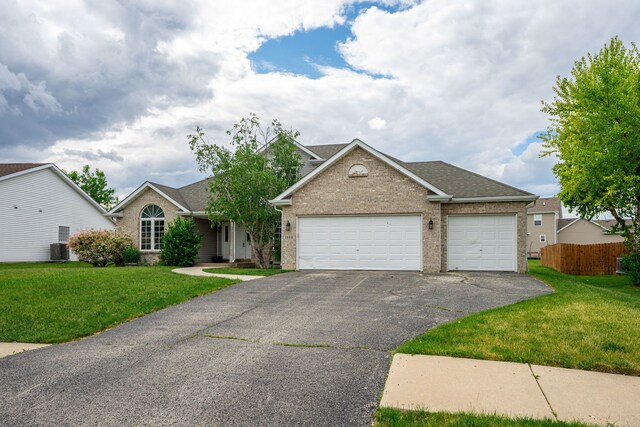 1924 Prestwold Pl, Machesney Park, IL 61115 - view of front facade with asphalt driveway, an attached garage, brick siding, central air condition unit, and roof with shingles