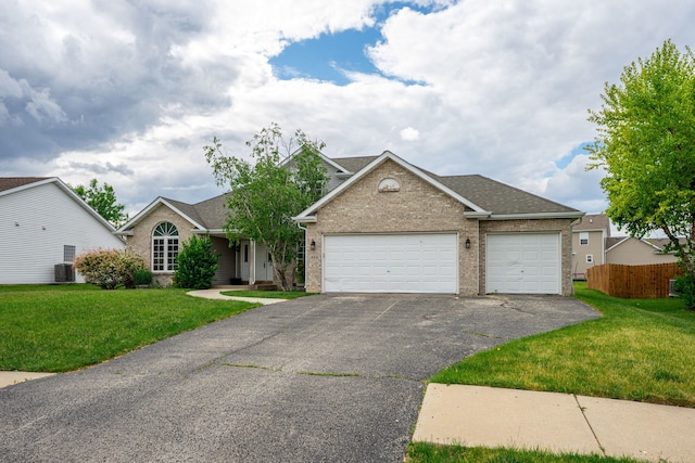 1924 Prestwold Pl, Machesney Park, IL 61115 - view of front of property featuring asphalt driveway, a garage, brick siding, central AC, and a shingled roof