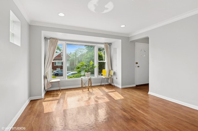 5200 S Mozart Ave, Chicago, IL 60632 - unfurnished room featuring crown molding, baseboards, wood finished floors, arched walkways, and recessed lighting