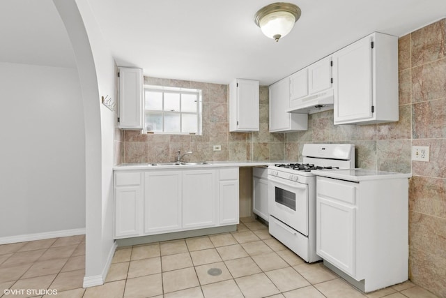 5200 S Mozart Ave, Chicago, IL 60632 - kitchen featuring white gas range oven, under cabinet range hood, light countertops, white cabinets, and light tile patterned floors
