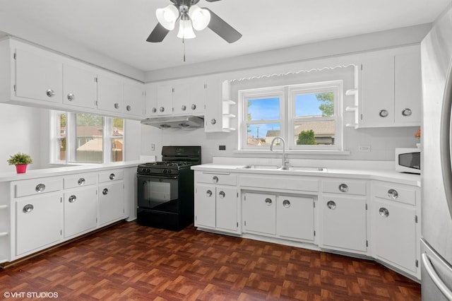 5200 S Mozart Ave, Chicago, IL 60632 - kitchen featuring black gas range oven, a sink, under cabinet range hood, open shelves, and white microwave
