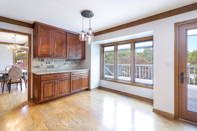 841 Turnbridge Cir, Naperville, IL 60540 - kitchen featuring a chandelier, light wood finished floors, backsplash, decorative light fixtures, and light stone countertops