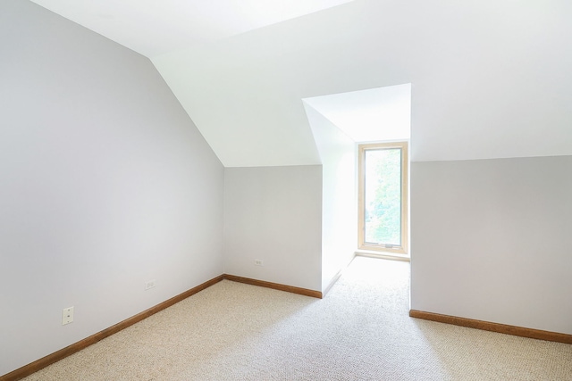 841 Turnbridge Cir, Naperville, IL 60540 - additional living space with vaulted ceiling, baseboards, and light carpet