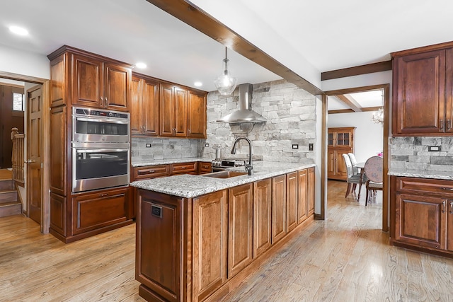 841 Turnbridge Cir, Naperville, IL 60540 - kitchen with wall chimney exhaust hood, stainless steel double oven, backsplash, light stone counters, and beamed ceiling