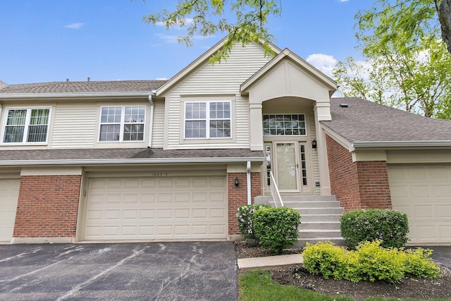1623 Camberley Ct, Bartlett, IL 60103 - view of front of home with brick siding, driveway, a shingled roof, and a garage