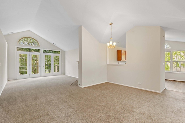 1623 Camberley Ct, Bartlett, IL 60103 - unfurnished living room with vaulted ceiling, plenty of natural light, a chandelier, carpet, and baseboards