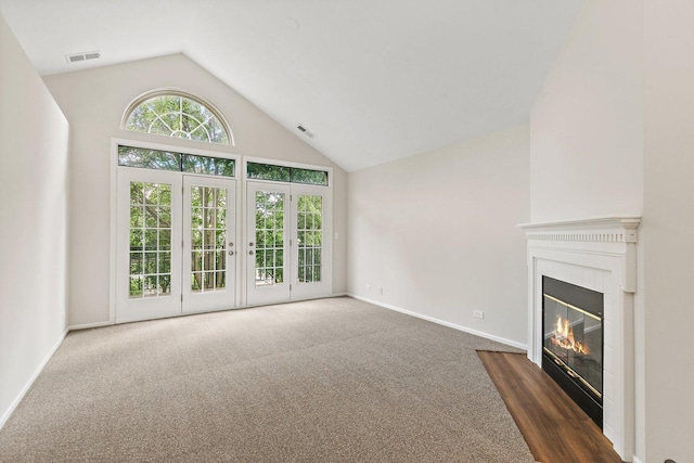 1623 Camberley Ct, Bartlett, IL 60103 - unfurnished living room with carpet floors, a glass covered fireplace, baseboards, and high vaulted ceiling